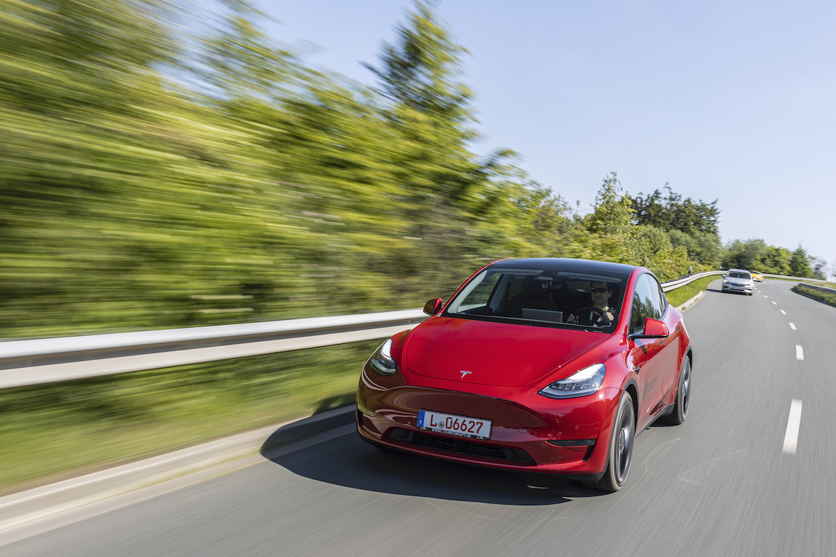 Red Tesla Model Y driving front